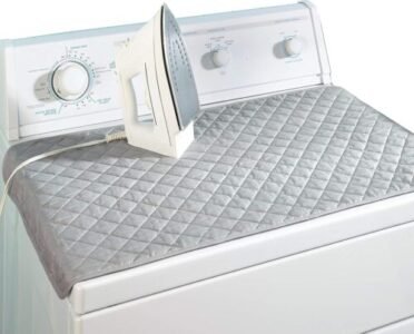 a iron on top of a washing machine