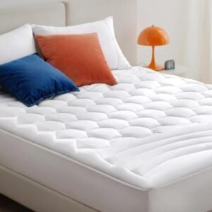 a bed with pillows and a lamp